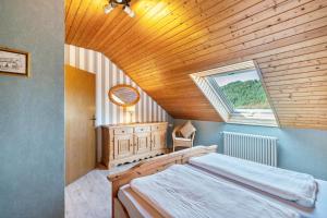 a bedroom with a large bed and a window at Haus Berger in Seebach
