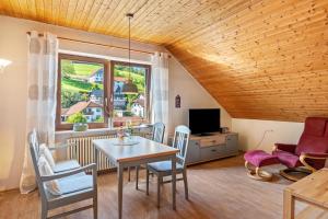 a living room with a table and chairs and a window at Haus Berger in Seebach