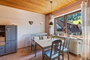 a dining room with a table and chairs and a window at Haus Berger in Seebach