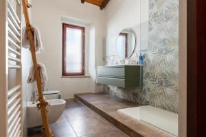 a bathroom with a sink and a toilet and a mirror at Somewhere Over the Hills in Terni
