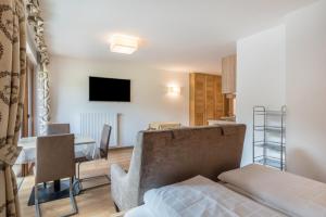 a living room with a couch and a table at Garni Hotel Gardena App Dolomites 3 in Santa Cristina Gherdëina