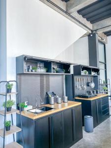 a kitchen with blue cabinets and a sink in it at X Hostel Jogja in Timuran