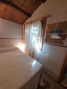 a bedroom with two beds and a window in it at Chalet Dominique in Azzana