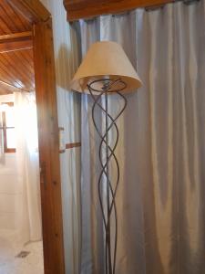 a floor lamp with a lamp shade in a room at Chalet Dominique in Azzana
