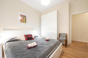 a bedroom with a large bed and a chair at Sa Babbajola in Cagliari