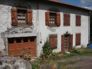 an old house with wooden doors and windows at Le Paillassou in Blanzac +3 photos