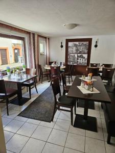a dining room with tables and chairs in a restaurant at Hotel Alt Cues in Bernkastel-Kues