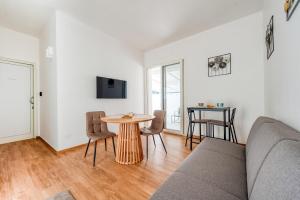a living room with a couch and a table at San Giorgio Rooms in Cavallino di Lecce