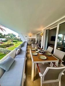 a living room with a long couch and a table at Parque Miraflores in Mijas