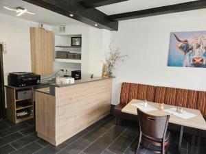 a restaurant with a counter and a table and chairs at Hotel Alt Cues in Bernkastel-Kues +26 photos