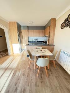 a kitchen and dining room with a table and chairs at Panoramic View apartment Seraidi Annaba in Annaba