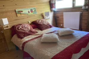a bedroom with a bed with two pillows on it at Chalet les Sonnailles in Mont-Dore +7 photos