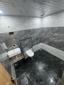 a bathroom with a sink and a toilet in it at iv hotel Ajmer in Madār