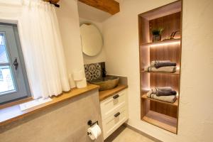 a bathroom with a sink and a mirror at Michels Mühle - Pitt sin Atelier in Brilon +37 photos