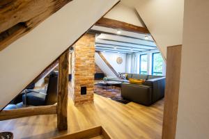 a loft conversion with a living room and a brick wall at Michels Mühle - Pitt sin Atelier in Brilon