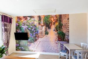 a wall mural of a street with flowers at Feel Free Apartment in Rheinböllen