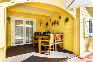 an arched patio with a table and chairs at Haus Miriam in Walchum +25 photos