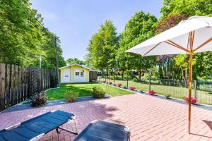 a patio with two chairs and an umbrella at Haus Miriam in Walchum