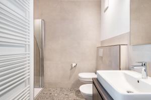 a bathroom with a toilet and a sink at Mountain Meadows Apt 1 in Valdaora +11 photos