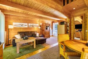 a living room with a couch and a table at Haus Miriam in Walchum