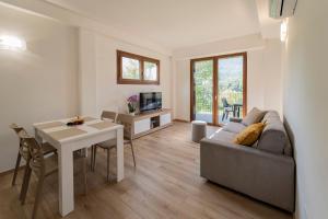 a living room with a couch and a table at Como home residence in Carlazzo