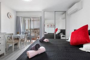 a bedroom with a large bed with red pillows on it at Apartamento Agata 2024 in Benalmádena +20 photos