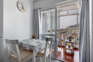 a dining room with a table and a large window at Apartamento Agata 2024 in Benalmádena