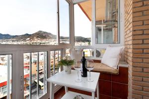 a balcony with a table and two glasses of wine at Apartamento Agata 2024 in Benalmádena