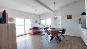 a kitchen and living room with a table and chairs at Dinkelbach Feriendomicil 2 C in Lindau-Bodolz