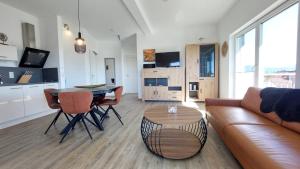 a living room with a couch and a table at Dinkelbach Feriendomicil 2 C in Lindau-Bodolz