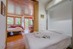 a bedroom with a large white bed in a room at Il nido nella Pineta Central in Ski resort - Happy Rentals in Bardonecchia