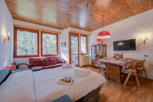a bedroom with a bed and a desk in a room at Il nido nella Pineta Central in Ski resort - Happy Rentals in Bardonecchia