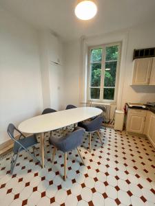 a kitchen with a table and chairs in a room at Villa Isabelle in Allevard