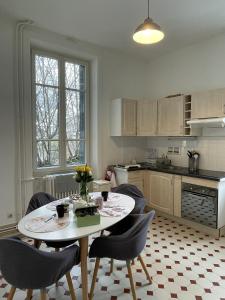 a kitchen with a table and chairs in a kitchen at Villa Isabelle in Allevard