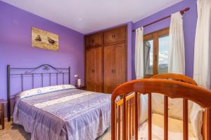 a purple bedroom with a bed and a window at Milano in Campo