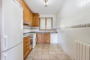 a kitchen with white appliances and wooden cabinets at Milano in Campo