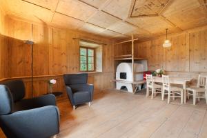 a living room with wooden walls and a table and chairs at Ansitz Baumannhof Apt Gotik in Falzes