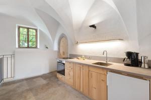 a kitchen with a sink and a counter top at Ansitz Baumannhof Apt Gotik in Falzes +24 photos
