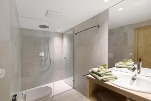 a bathroom with a shower and a sink and a toilet at Ansitz Baumannhof Apt Gotik in Falzes
