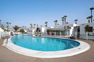 a large swimming pool in front of a building at Puerto Chico T in Playa Blanca