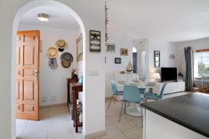 a kitchen and living room with a table and chairs at Puerto Chico T in Playa Blanca