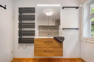 a bathroom with a sink and a mirror at Ferienhaus Bergmann mit Sauna in Wildemann +19 photos