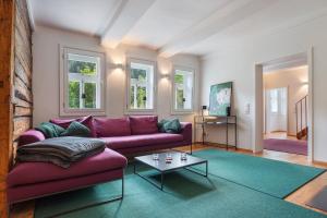 a living room with a purple couch and a table at Ferienhaus Bergmann mit Sauna in Wildemann