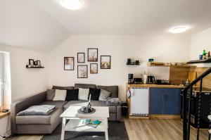 a living room with a couch and a table at Ferienwohnung Didi in Detern