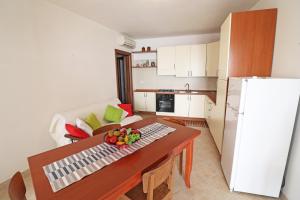 a small kitchen with a table and a refrigerator at Casa Vacanze Martina a Otranto in Otranto +23 photos