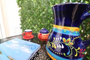 a blue vase sitting on top of a table at Casa Vacanze Martina a Otranto in Otranto