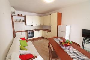 a kitchen and dining room with a table and a couch at Casa Vacanze Martina a Otranto in Otranto
