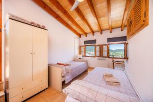 a bedroom with two beds and a closet at Eliasneil in Andratx