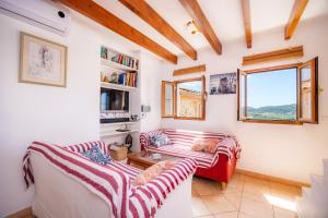 a living room with two couches and a window at Eliasneil in Andratx
