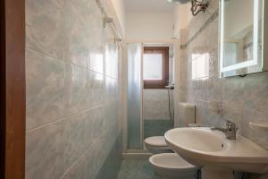 a bathroom with two toilets and a sink at Appartamento Croce del Sud 8 in Bibione +17 photos